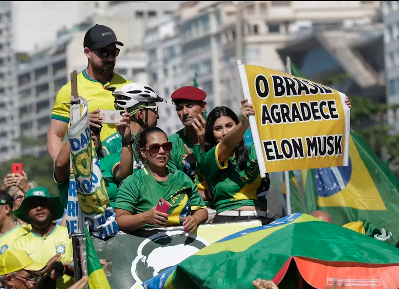 Brazilian people protest holding Elon Musk sign