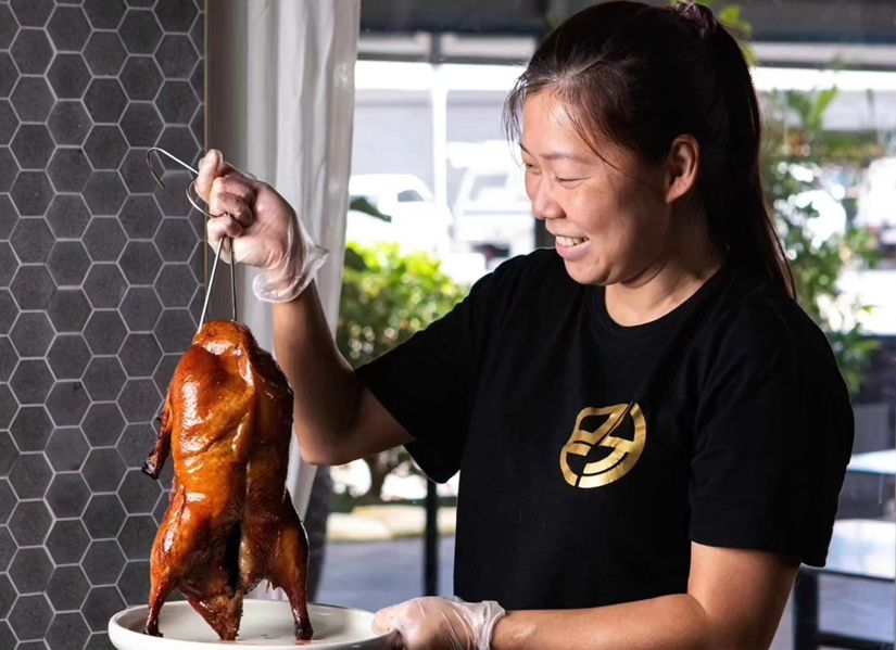 Emily holding a roast duck