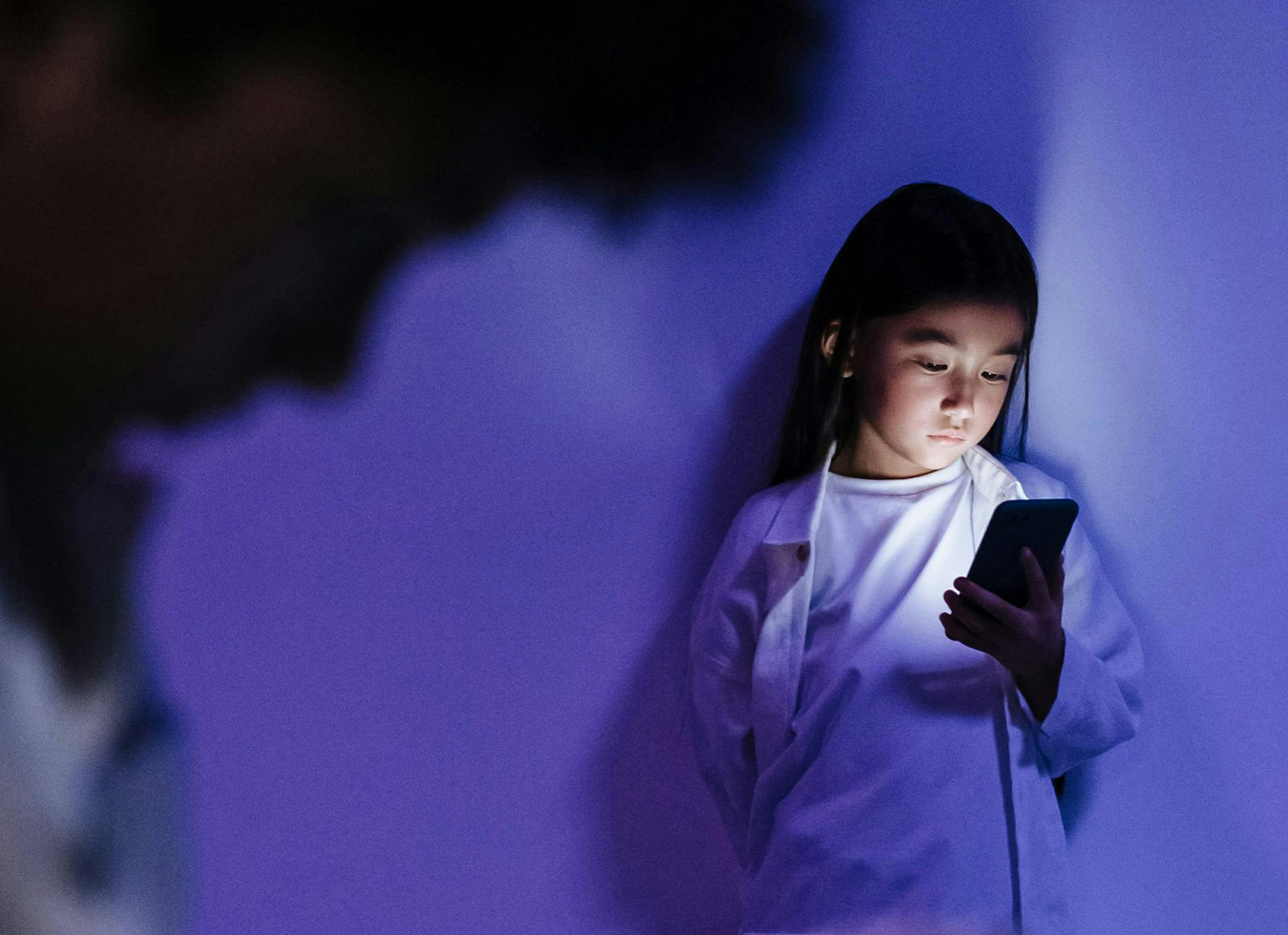 Young girl looking at her phone