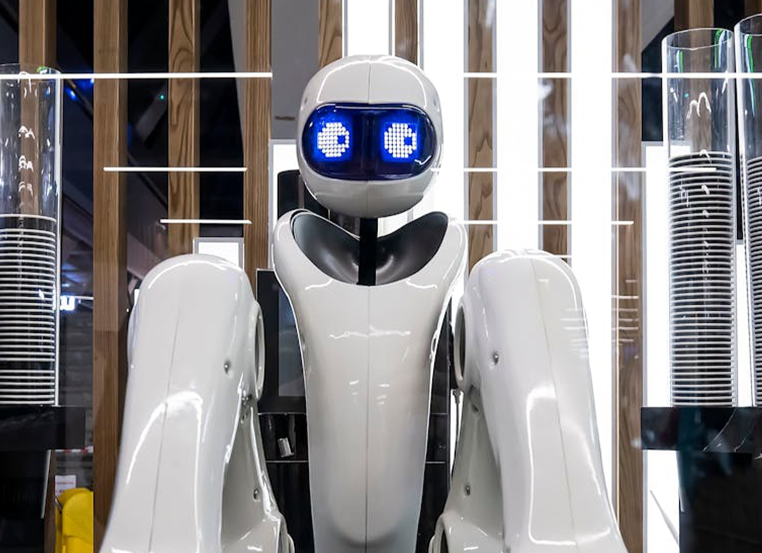 A white robot with blue and white eyes looking to the side