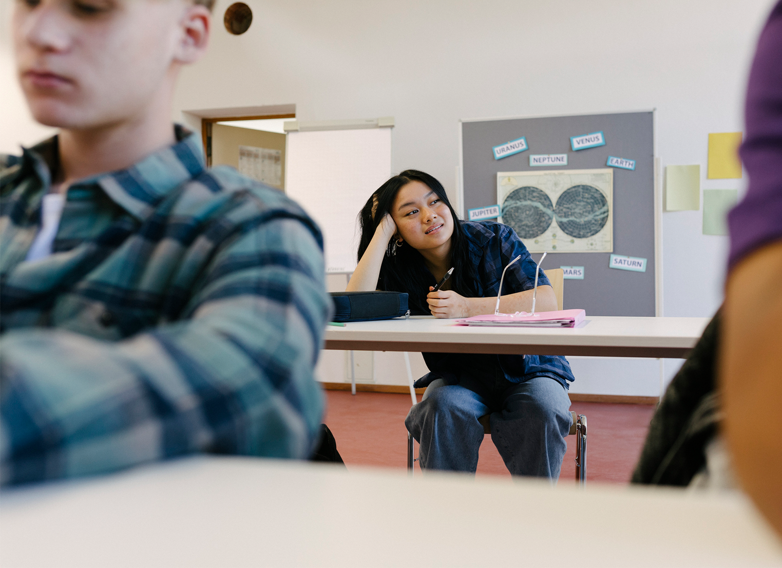 Girl in classroom daydreaming