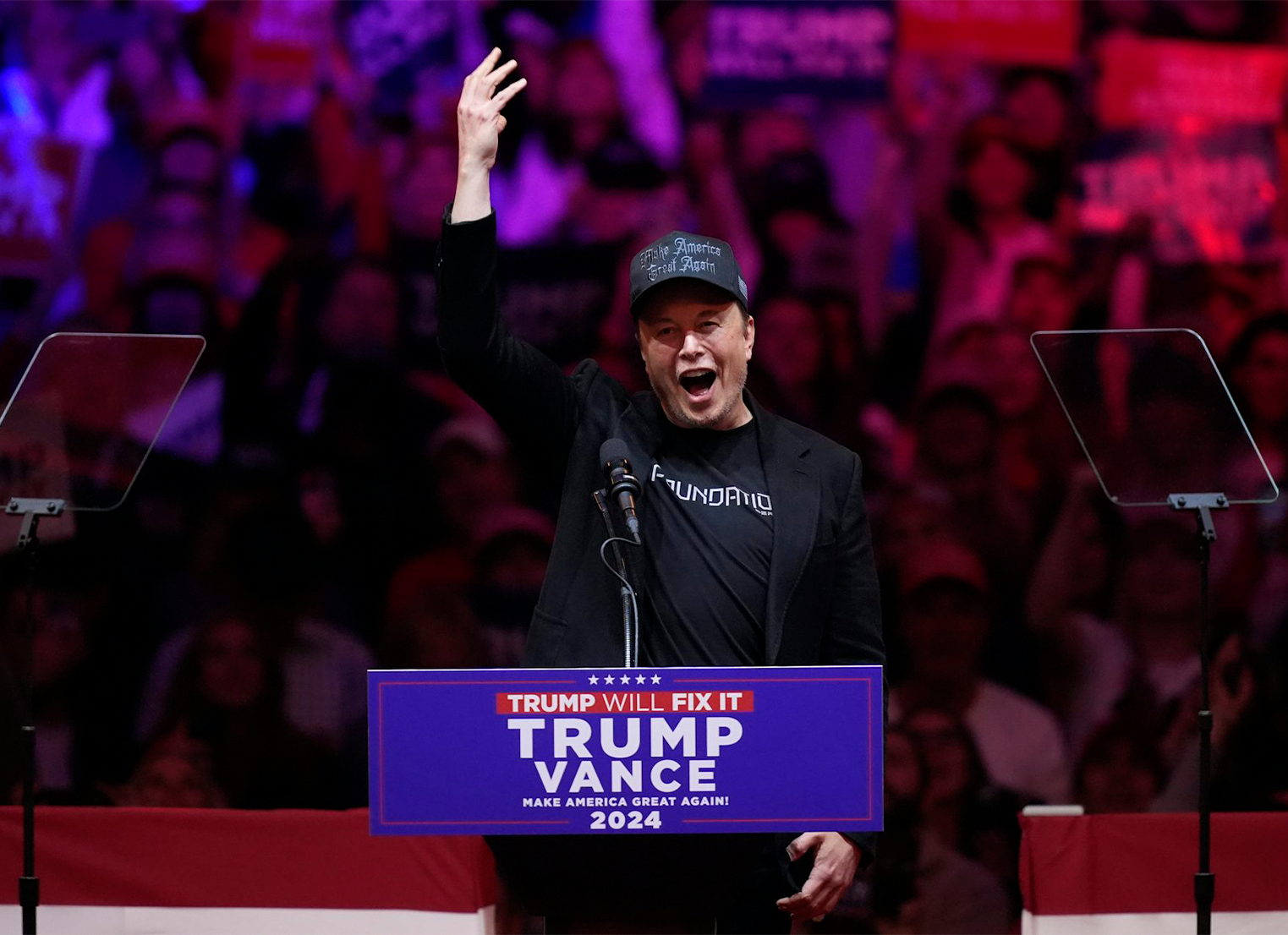 Elon Musk speaks at a Trump rally wearing a Make America Great Again cap