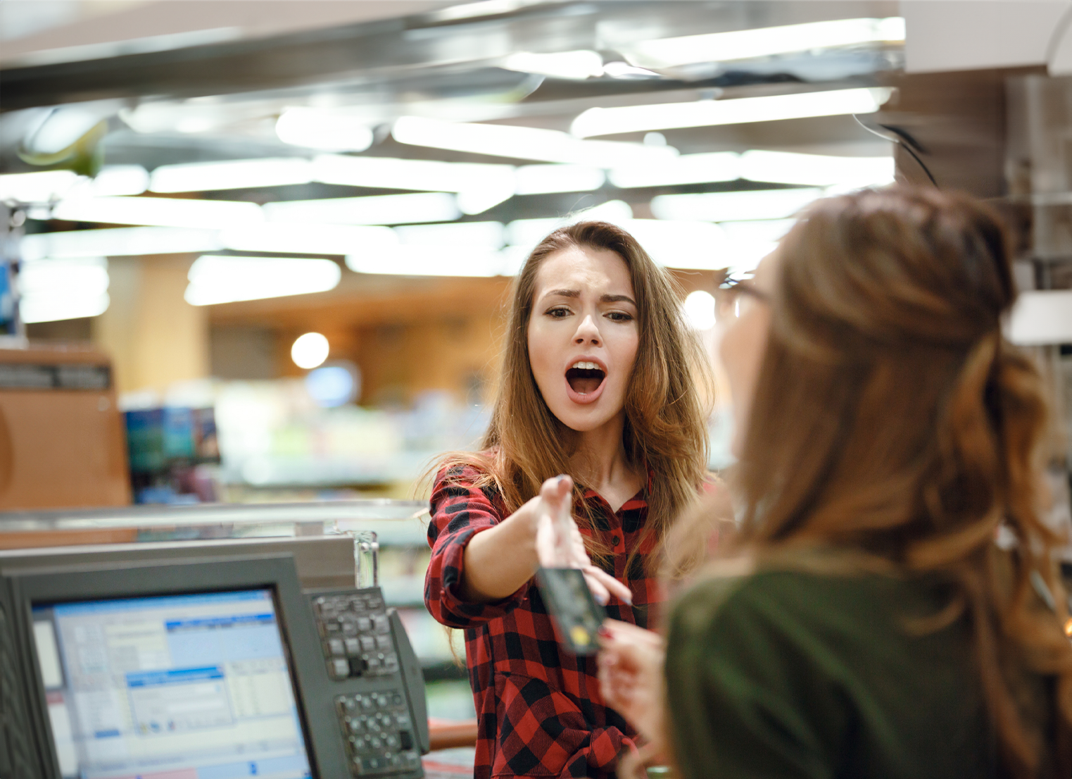 Woman shouting at retail cashier