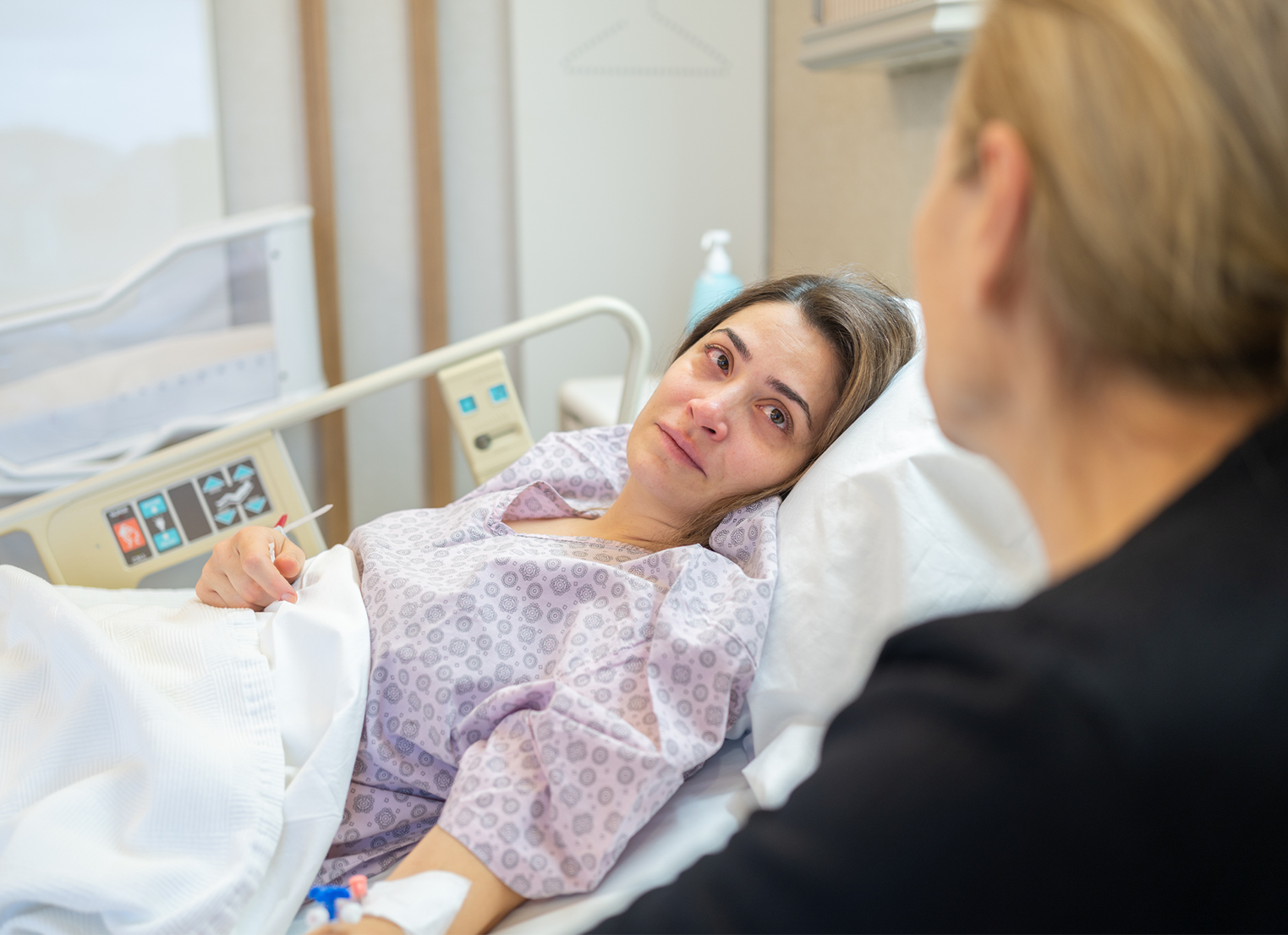 Sick woman in hospital bed