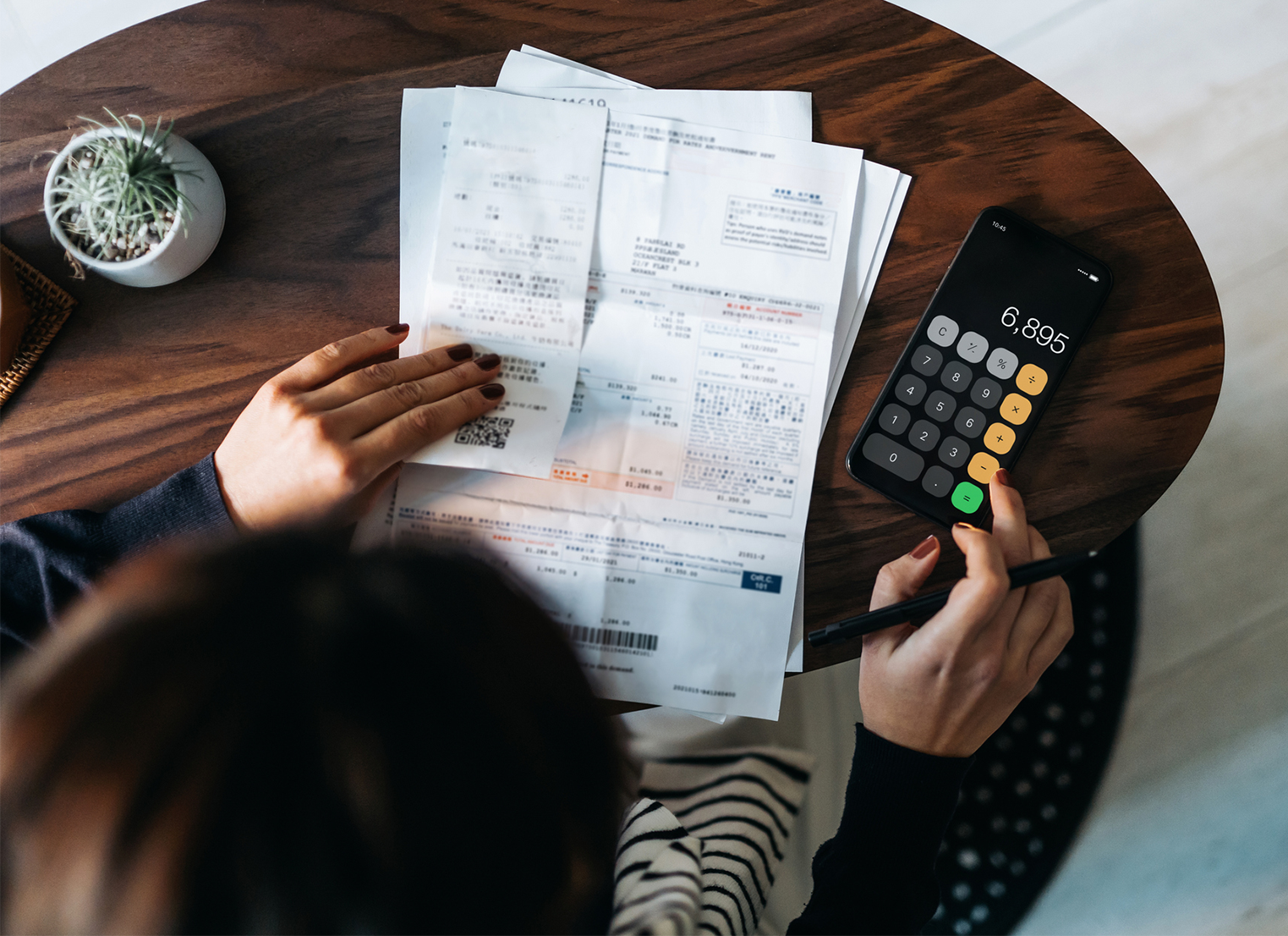 Woman doing paperwork with calculator